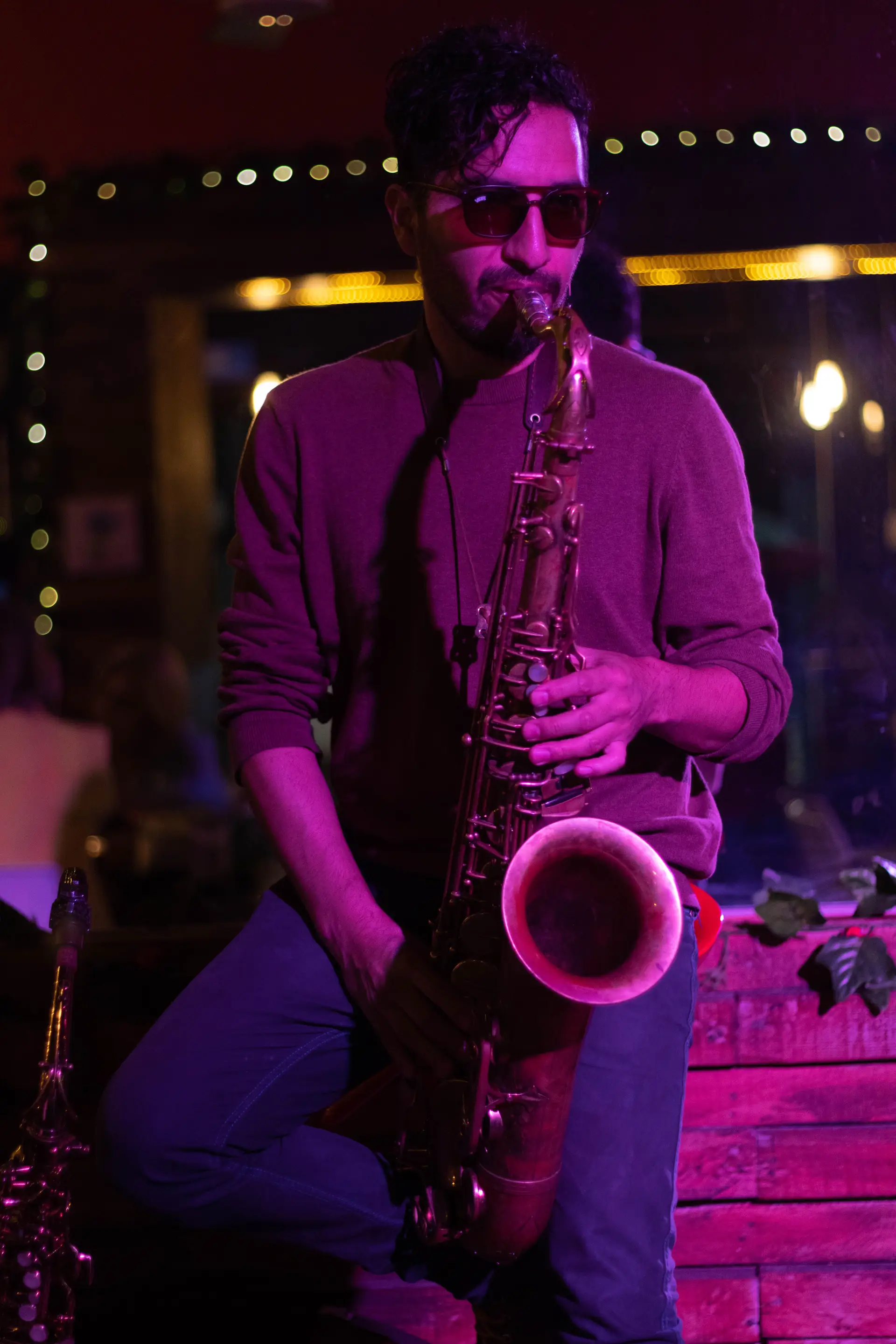 Saxophonist playing during a night performance