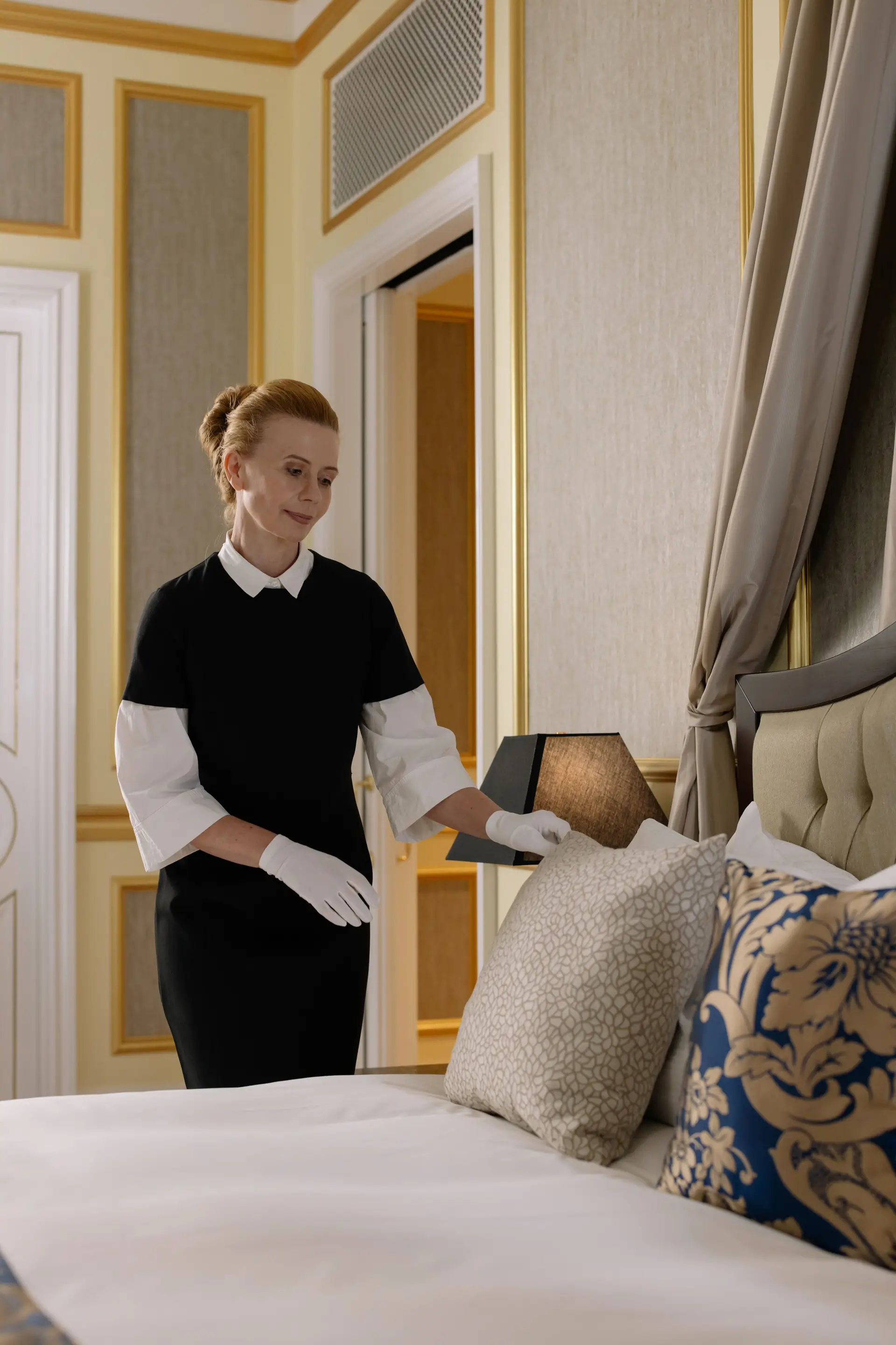 Hospitality staff ensuring room perfection